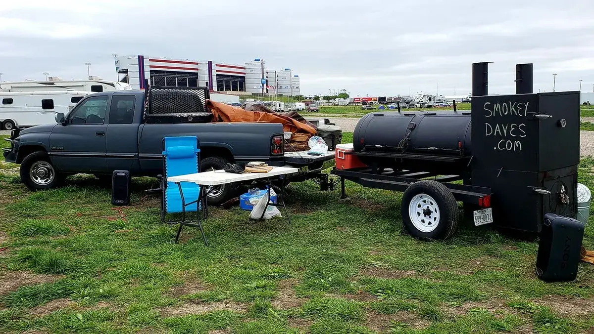Smokey Dave's smoker and serving tables set up at an event