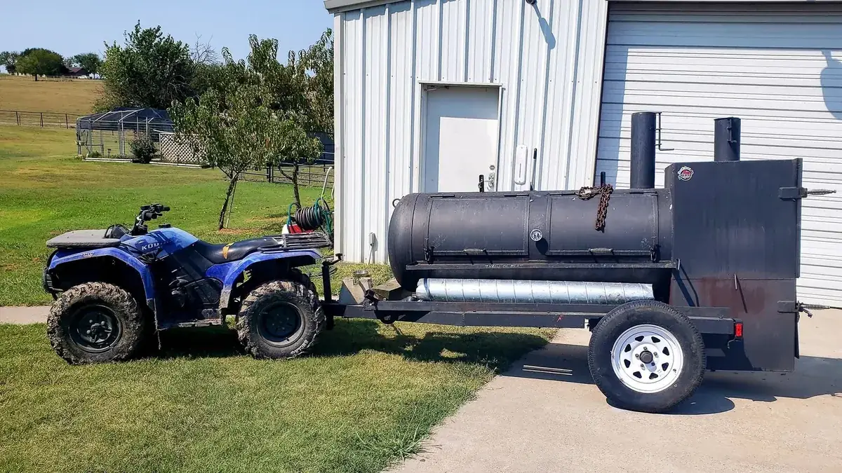 Trinity smoker trailer hitched to an ATV